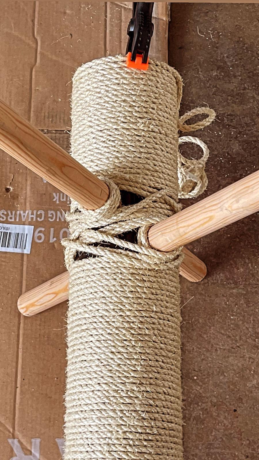 Detailed jute rope wrapping at the joint between the column and the wooden crossbar.