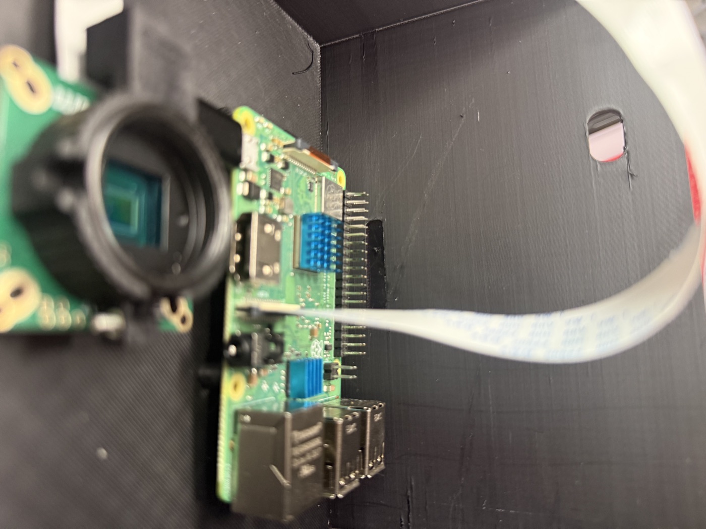 Pi mounted in the printed enclosure interior with the camera mounted nearby